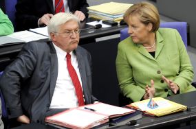Steinmeier und Merkel sitzen zusammen im Plenarsaal des Reichstagsgebäudes.
